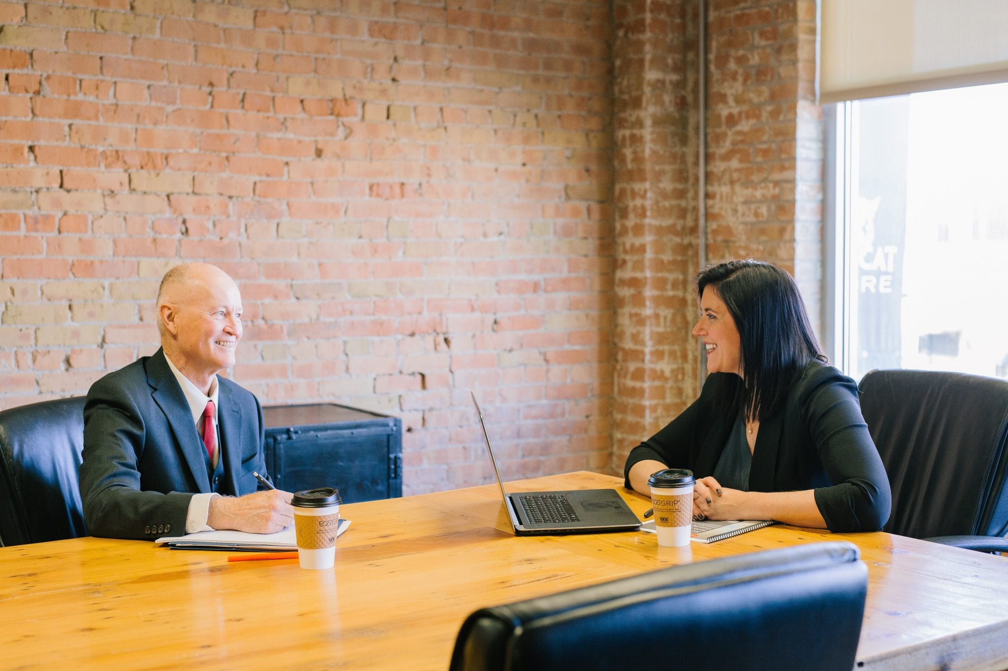 Two people in an interview at a meeting table