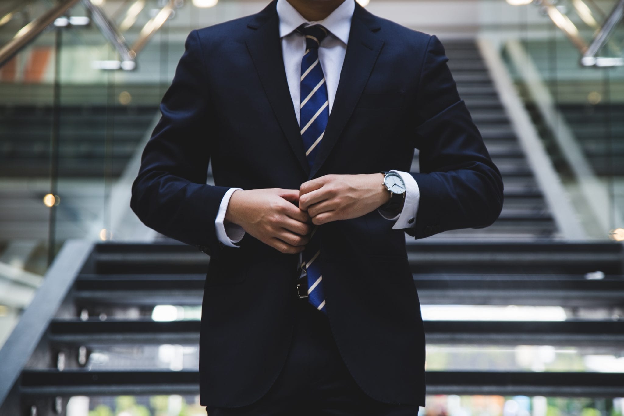 Man in a suit walking down stairs